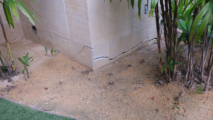View of crack in the external corner wall of a home caused by settlement